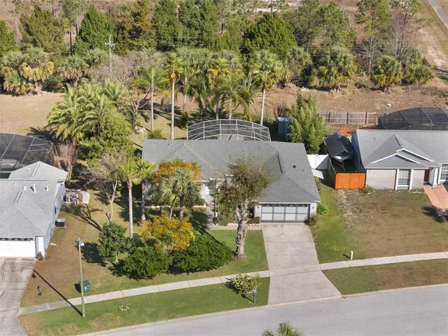 an aerial view of a house with a yard