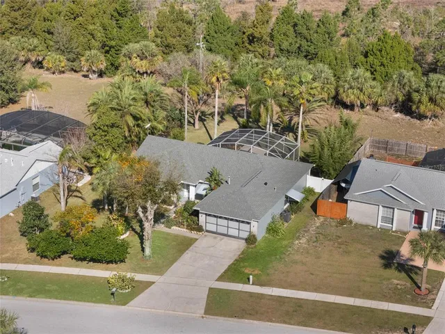 an aerial view of a house with a yard