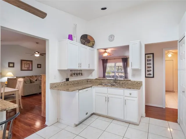 a kitchen with granite countertop a sink and cabinets