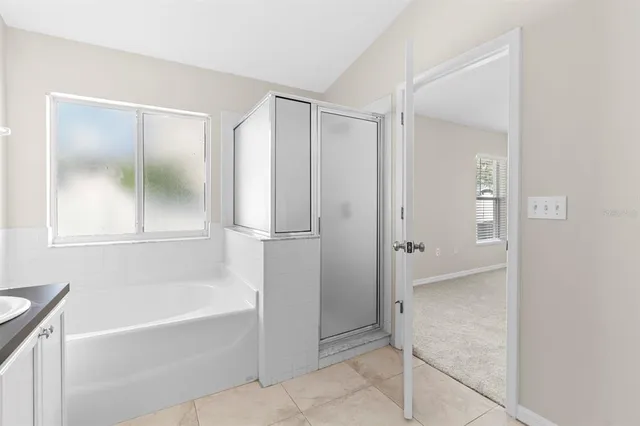 a bathroom with a bathtub and a shower