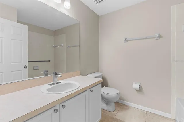 a bathroom with a sink toilet and a mirror