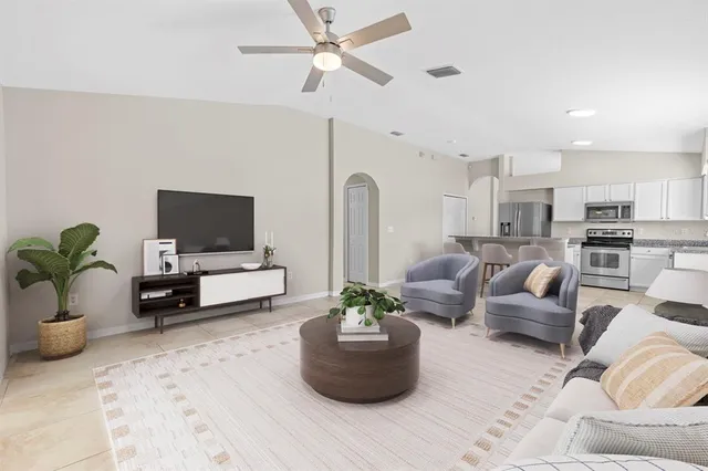 a living room with furniture and a flat screen tv