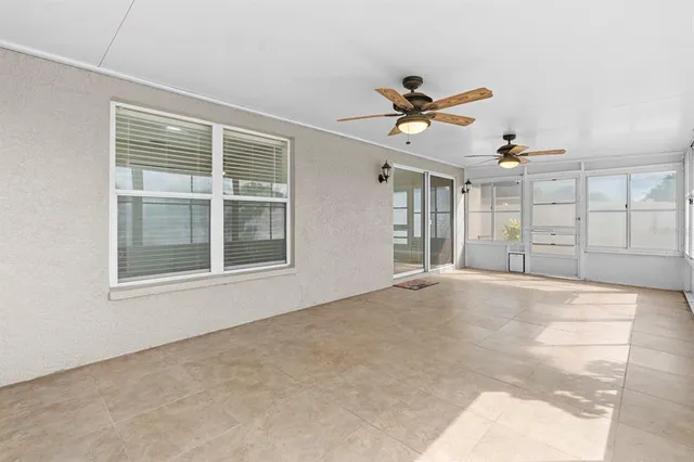 a view of a livingroom with a ceiling fan and window