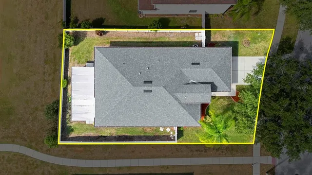 an aerial view of a house with a yard
