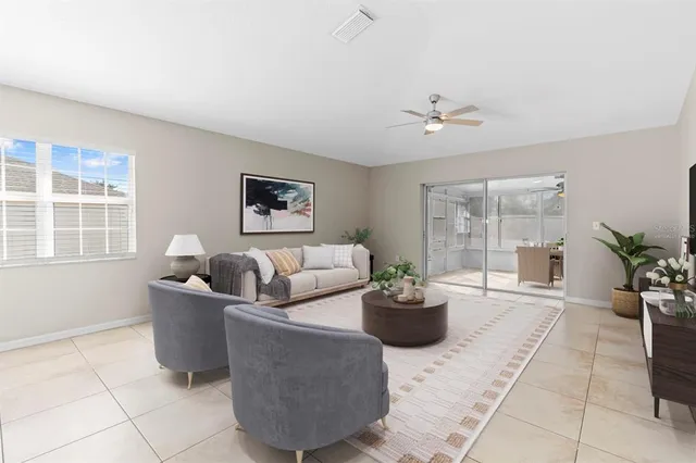 a living room with furniture and a potted plant