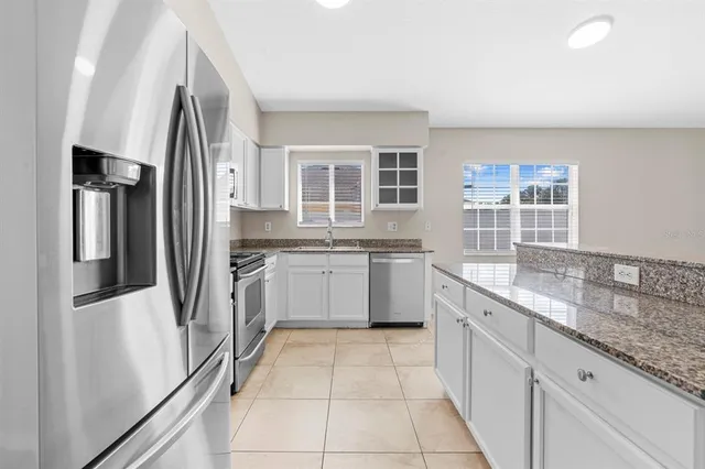 a kitchen with a sink stove and refrigerator