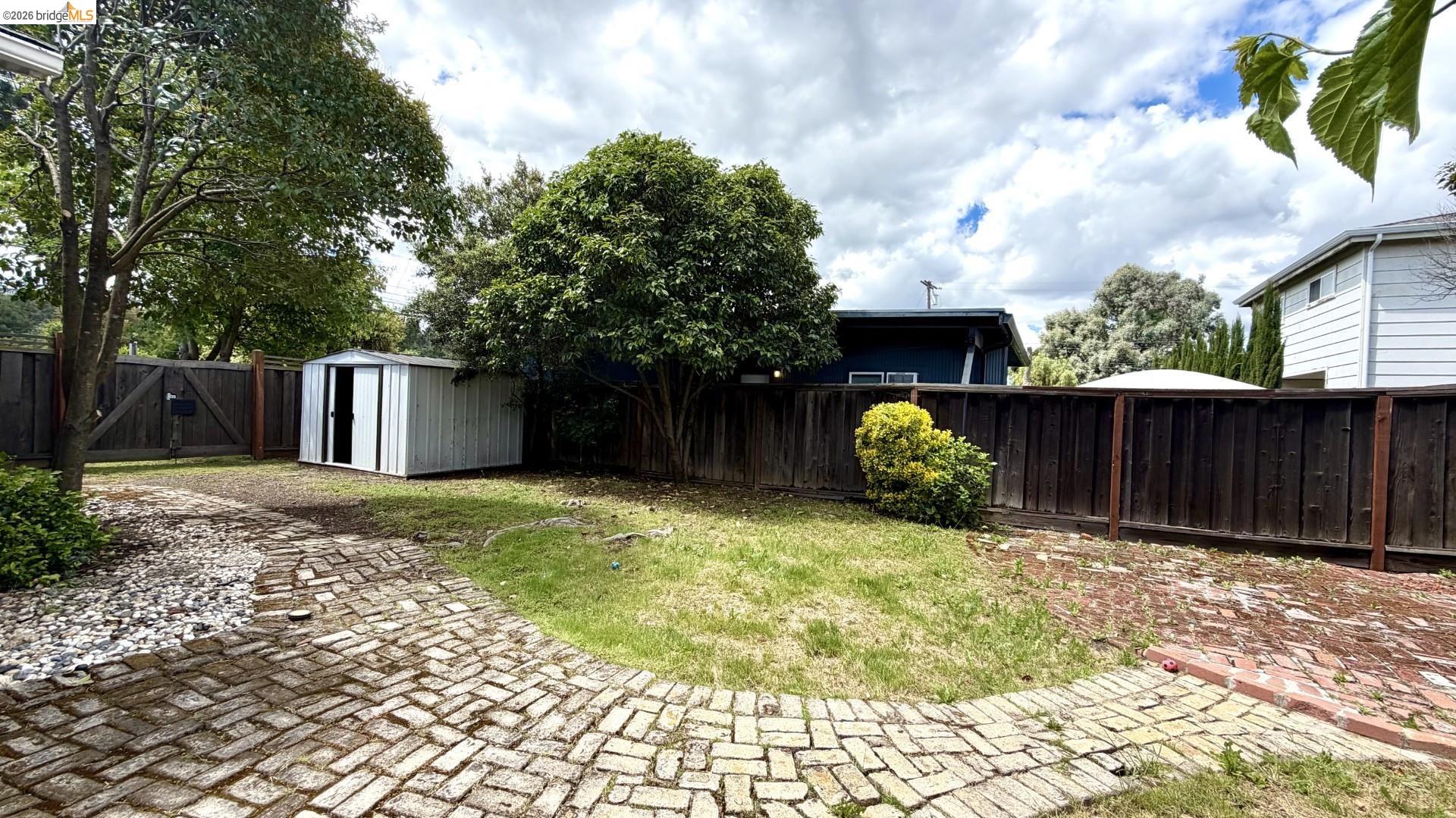 3407 Cowell Road Concord, CA 94518 - Photo 21 of 24 Fenced backyard with a storage unit and a patio area