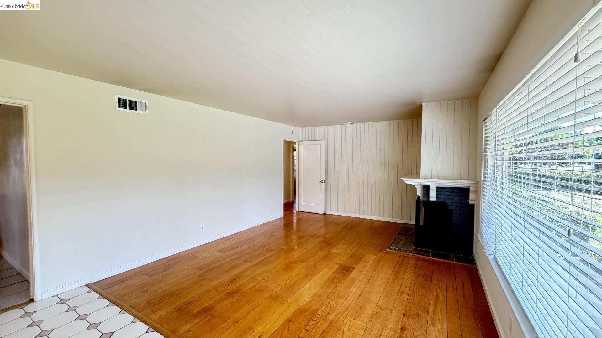 3407 Cowell Road Concord, CA 94518 - Photo 5 of 24 Unfurnished living room featuring light wood-type flooring and baseboards