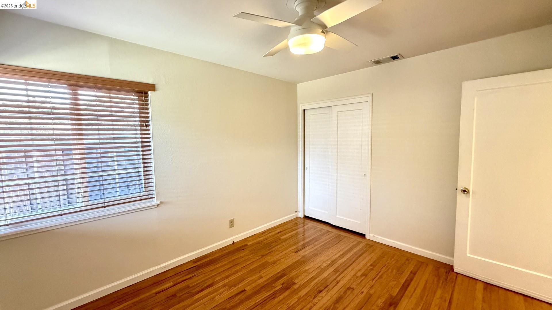 3407 Cowell Road Concord, CA 94518 - Photo 7 of 24 Unfurnished bedroom with wood-type flooring, a closet, and a ceiling fan