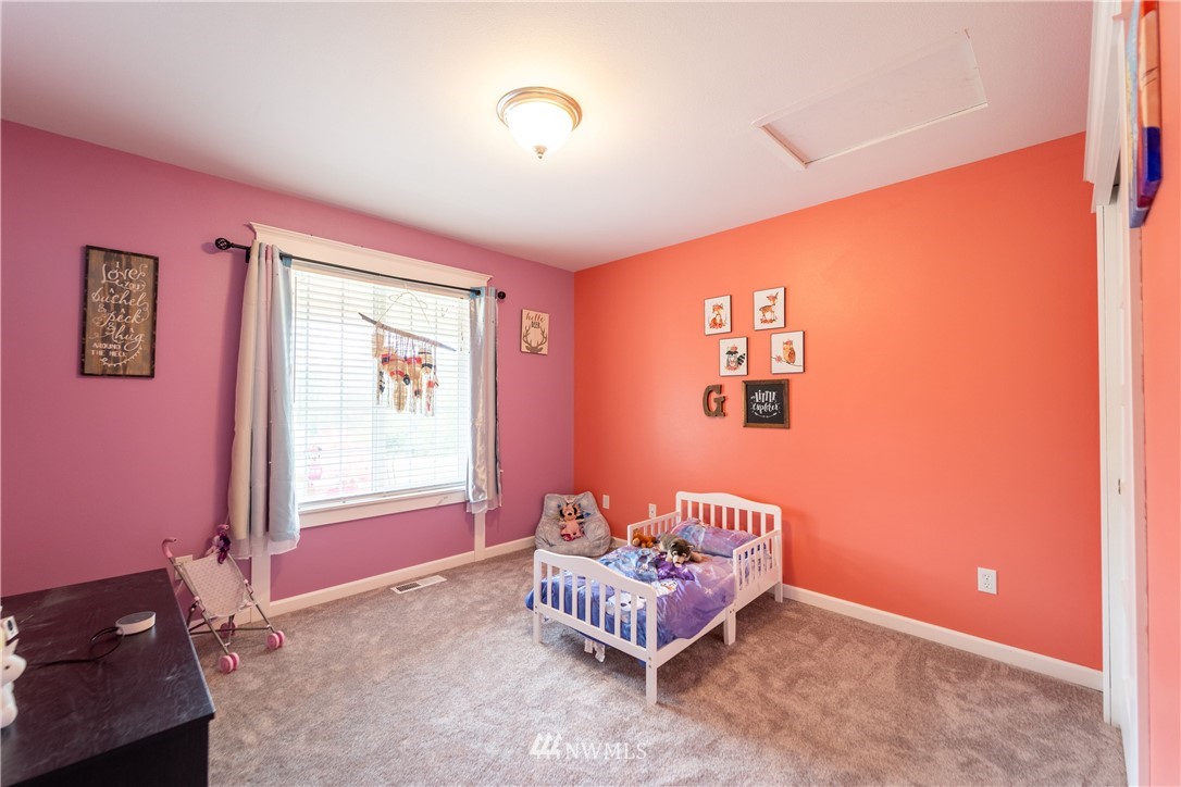 111 Garrett Loop Chehalis, WA 98532 - Photo 13 of 36 a bedroom with a bed and a window