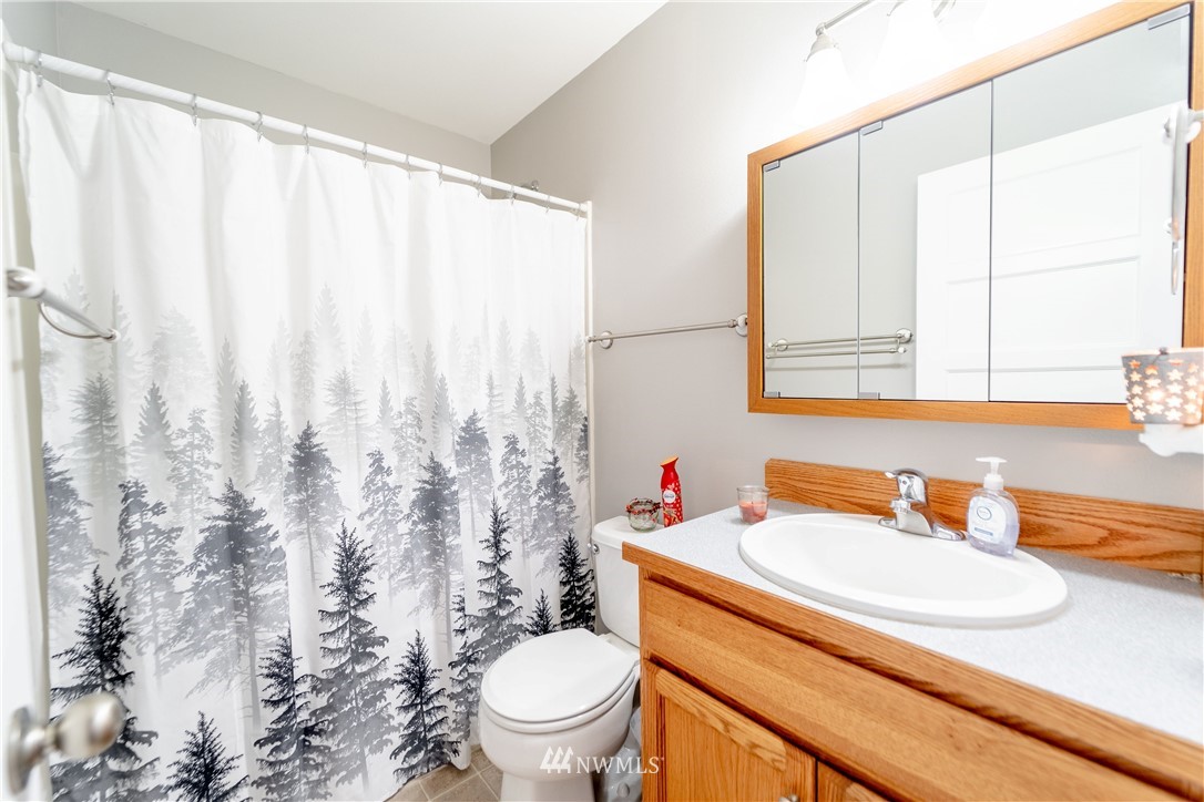 111 Garrett Loop Chehalis, WA 98532 - Photo 14 of 36 a bathroom with a granite countertop sink and a mirror
