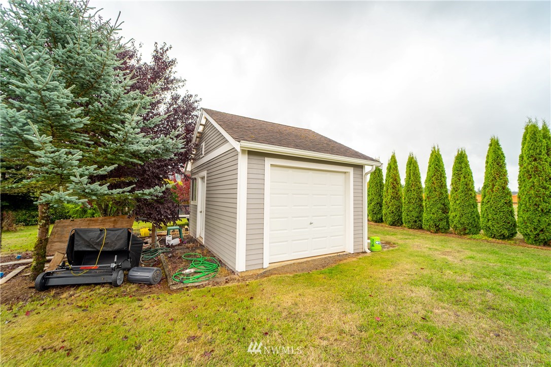 111 Garrett Loop Chehalis, WA 98532 - Photo 24 of 36 a view of a backyard with couches under an umbrella