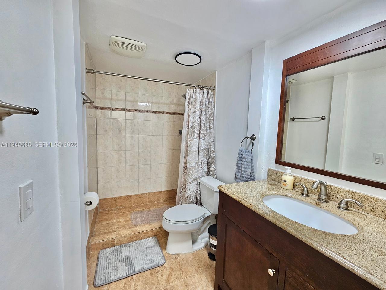0 West Th Hialeah, FL 33014 - Photo 18 of 21 a bathroom with a granite countertop sink toilet and shower