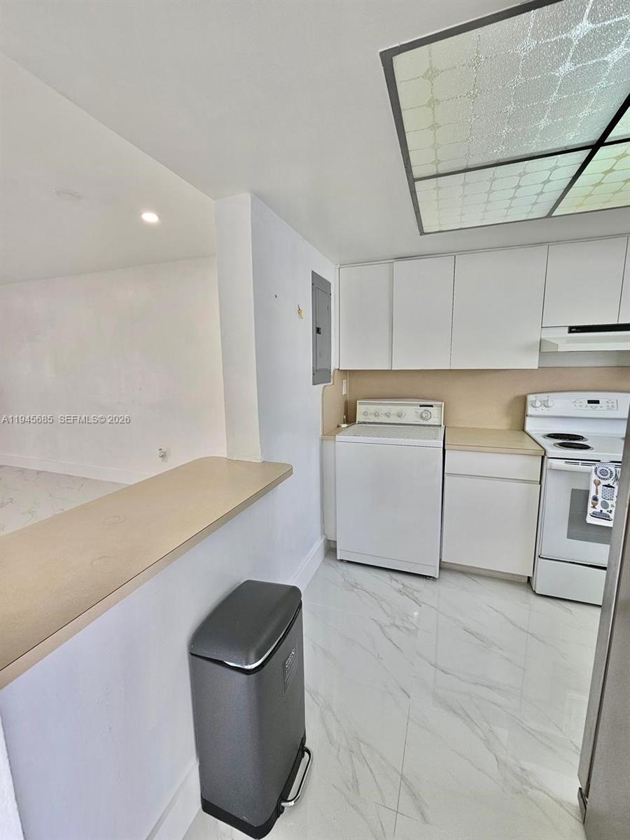 0 West Th Hialeah, FL 33014 - Photo 6 of 21 a kitchen with a sink and a refrigerator