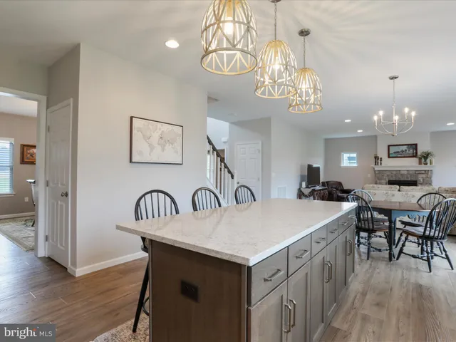 a view of a dining room with furniture wooden floor and chandelier