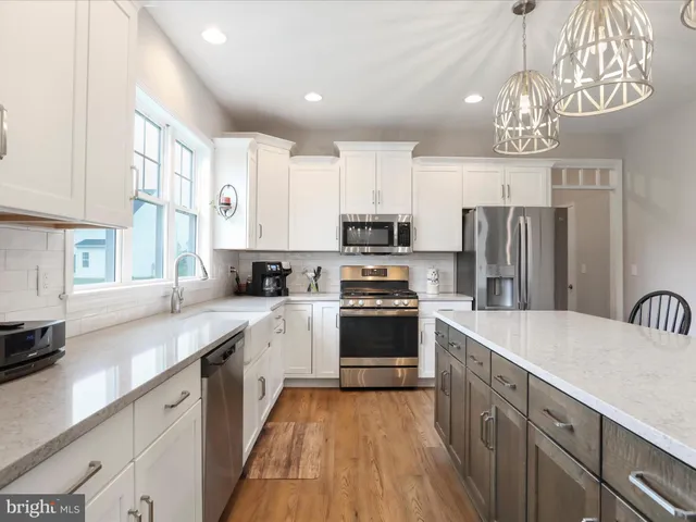 a view of a livingroom with furniture window and wooden floor