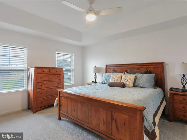 a bedroom with a bed and a large mirror on dresser