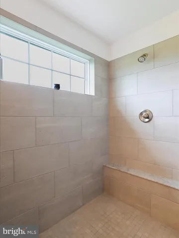 a view of walk in closet with clothes