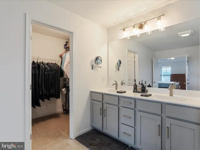 a view of living room with furniture and a view of bedroom
