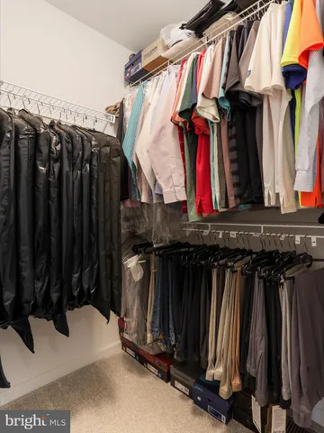 a bedroom with a bed next to a window