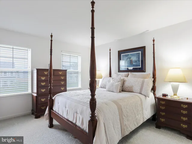 a bedroom with a bed and a lamp