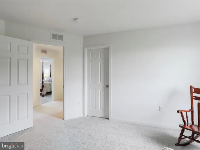 a bathroom with a double vanity sink toilet and a mirror