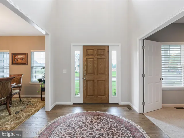 a view of a bedroom with furniture and window