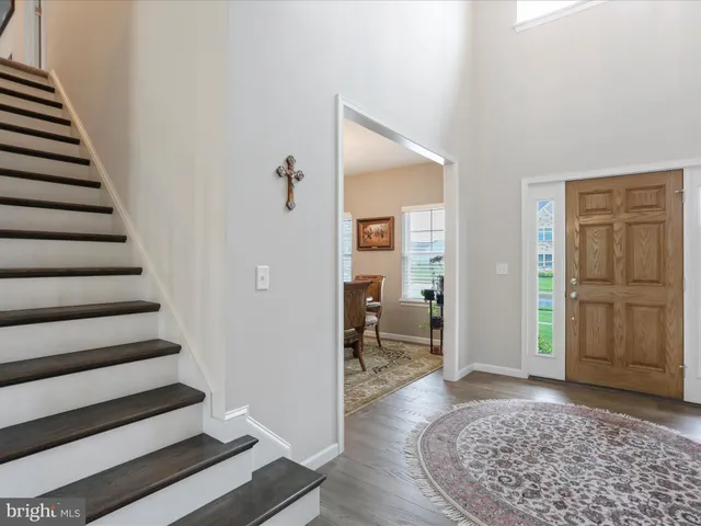 a view of a hallway with wooden floor and entryway