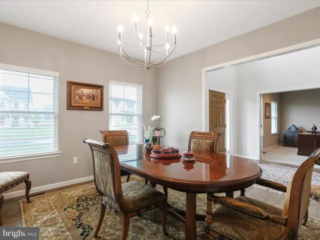 a view of a dining room with furniture and window
