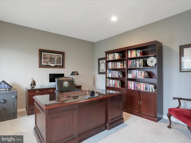 a work room with furniture and book shelf