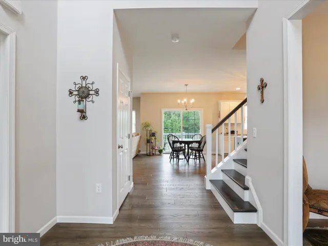 a view of dining room with wooden floor and furniture