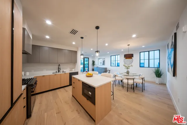 a large kitchen with a table and chairs