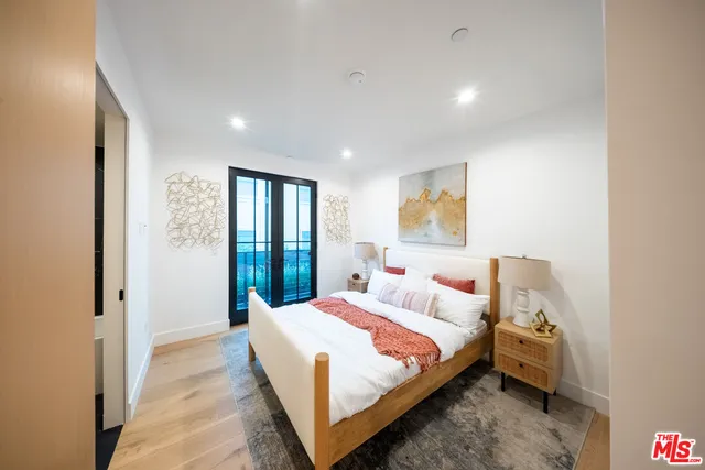 a bedroom with a large bed and a window