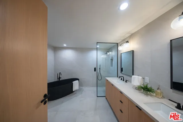 a large bathroom with a double vanity sink and mirror