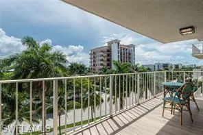 a view of a balcony with two chairs and a table