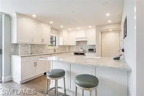 a kitchen with stainless steel appliances granite countertop a sink and a refrigerator