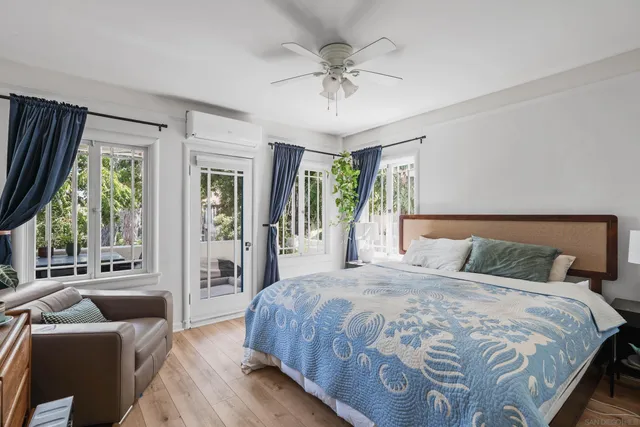 a bedroom with a large bed and a chandelier