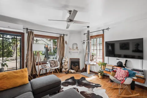 a view of a workspace with furniture and a window