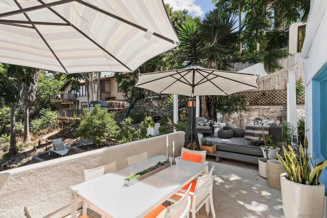 a view of a patio with table and chairs and potted plants