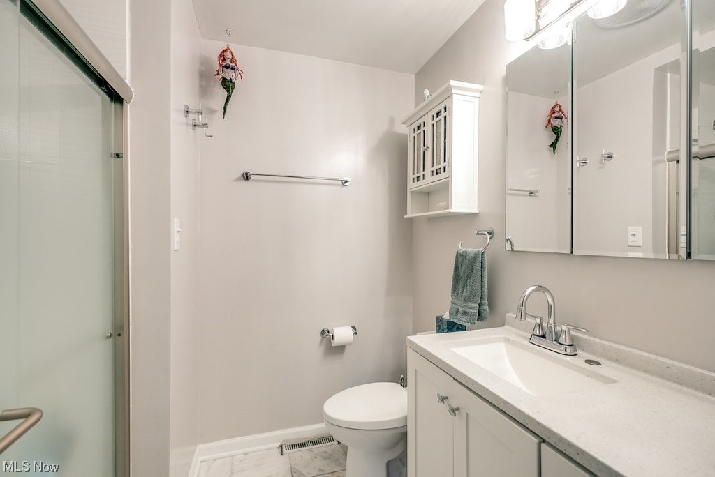 4828 South Sedgewick Road Cleveland, OH 44124 - Photo 10 of 19 Bathroom featuring toilet, tile floors, and large vanity