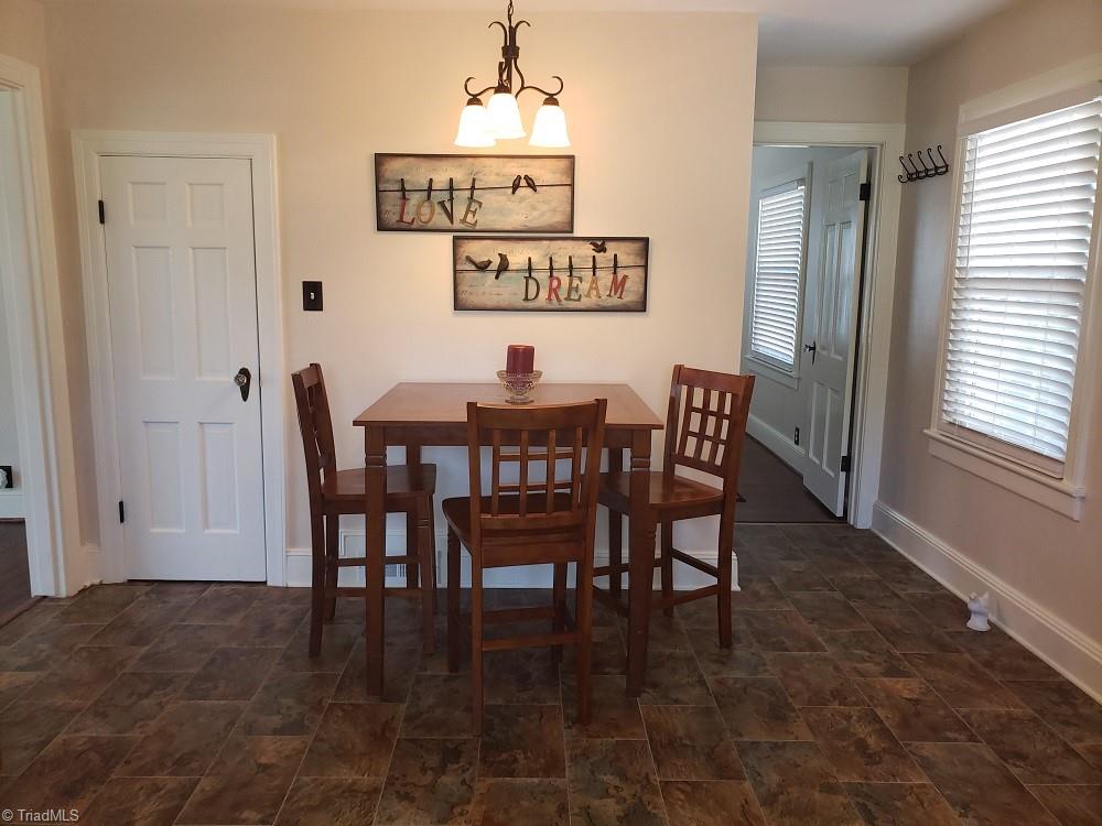 1694 Phillips Road Sandy Ridge, NC 27046 - Photo 6 of 25 Dining area with pantry on the left and access to the staircase on the right.