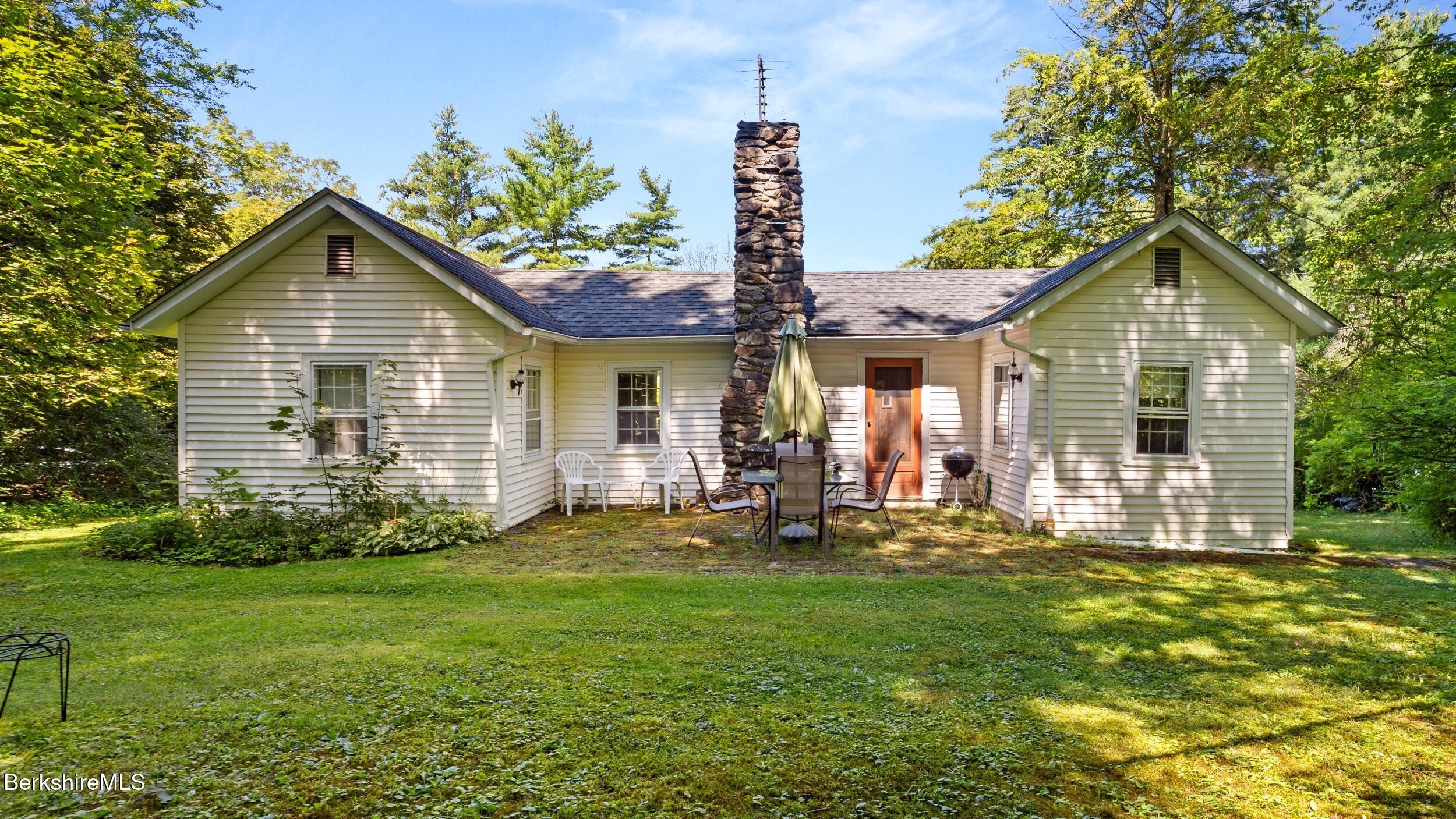 a front view of a house with a yard and staircase