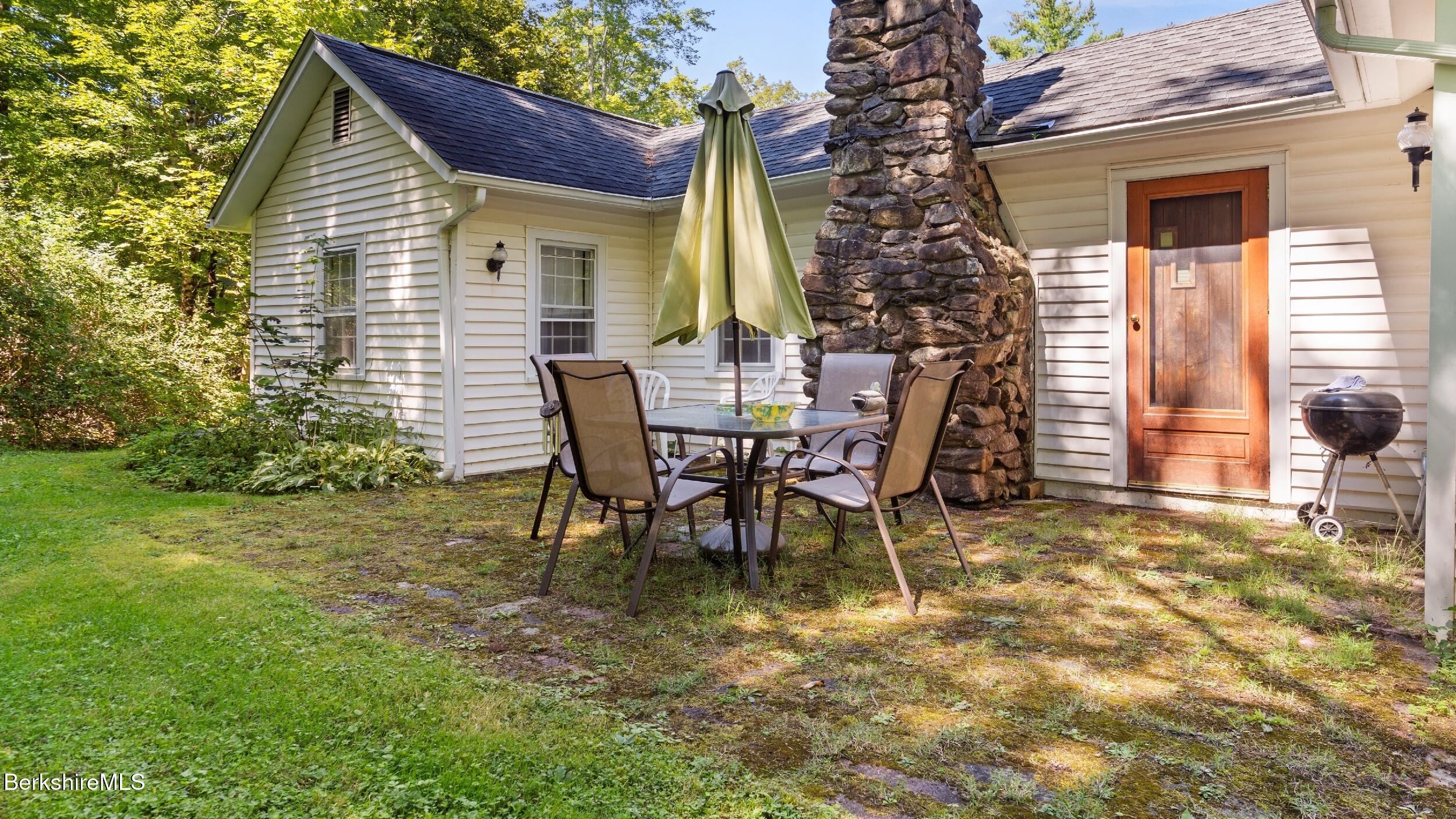 7 Mahkeenac Heights Road Stockbridge, MA 01262 - Photo 13 of 17 a view of a house with backyard and sitting area