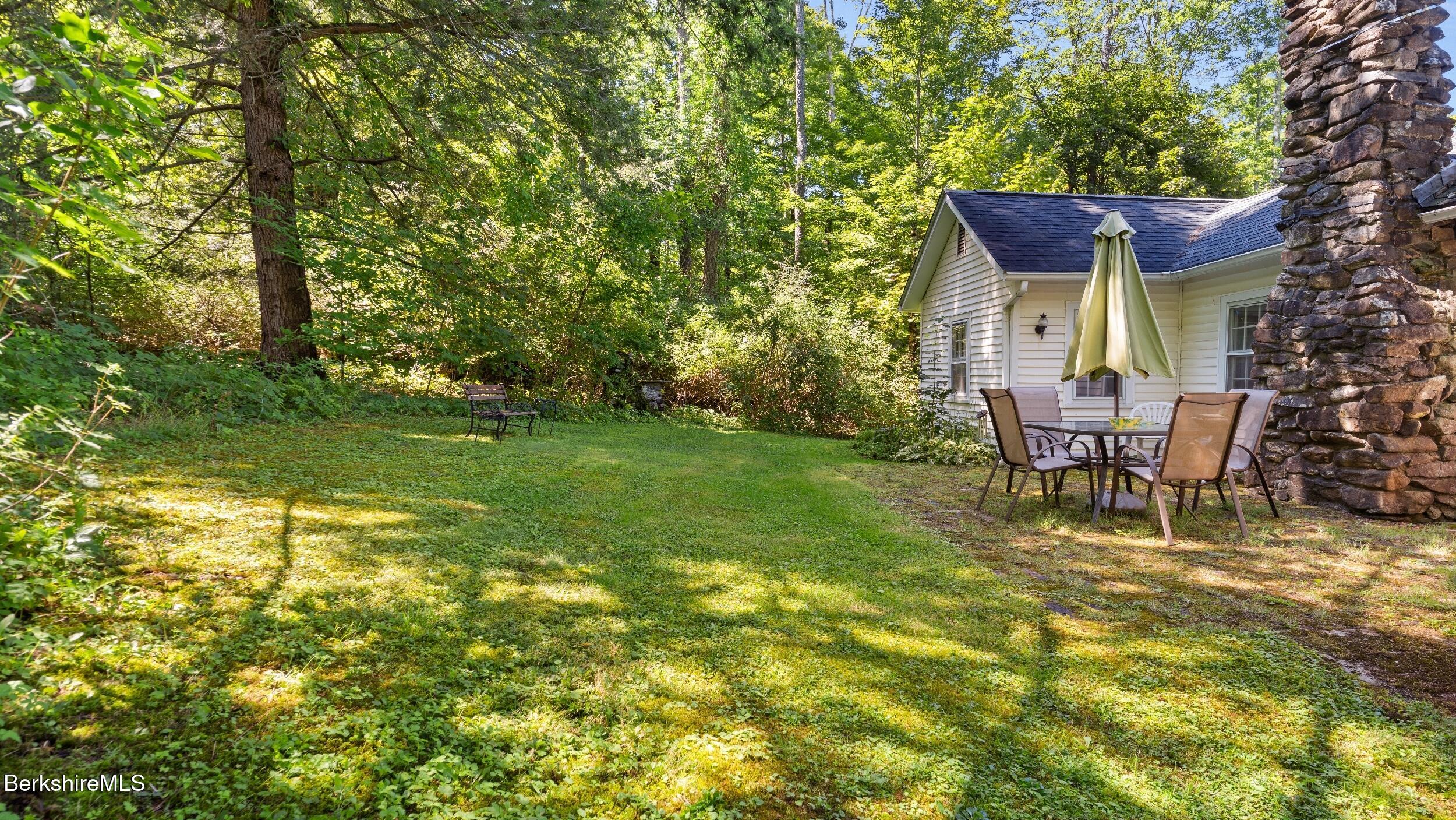 7 Mahkeenac Heights Road Stockbridge, MA 01262 - Photo 14 of 17 a view of a wooden house with a yard and sitting area