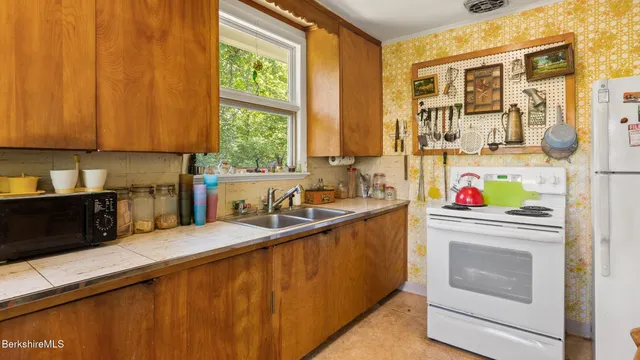 a kitchen that has a sink and a stove in it