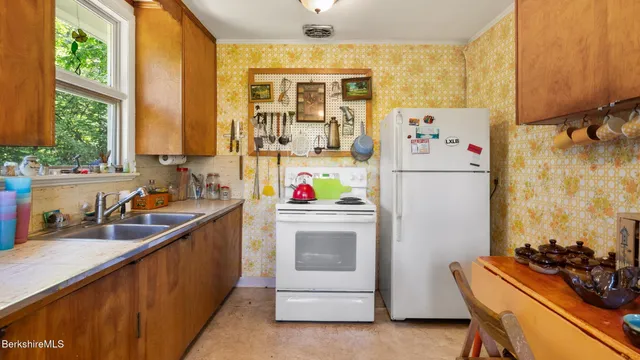 a kitchen with a refrigerator and a sink