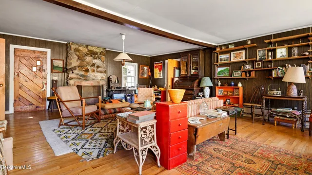a living room with lots of furniture and a large window