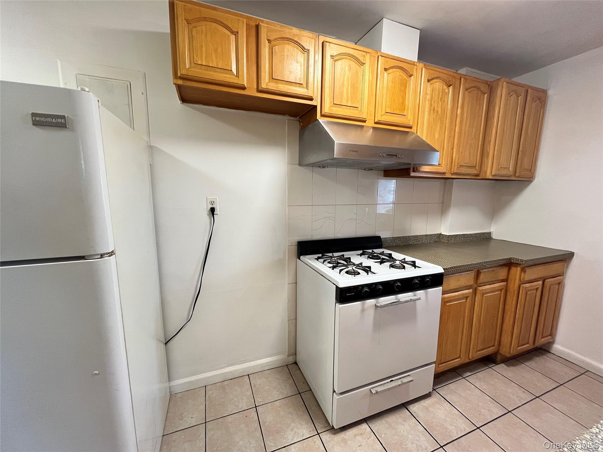 133-38 Avery Avenue, Unit 3FB Queens, NY 11355 - Photo 2 of 8 a kitchen with stainless steel appliances granite countertop a refrigerator and a stove top oven