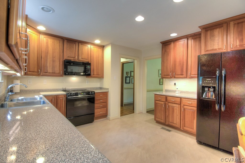 3111 East Brigstock Road Midlothian, VA 23113 - Photo 9 of 32 a modern kitchen with stainless steel appliances granite countertop a refrigerator stove top oven and large window