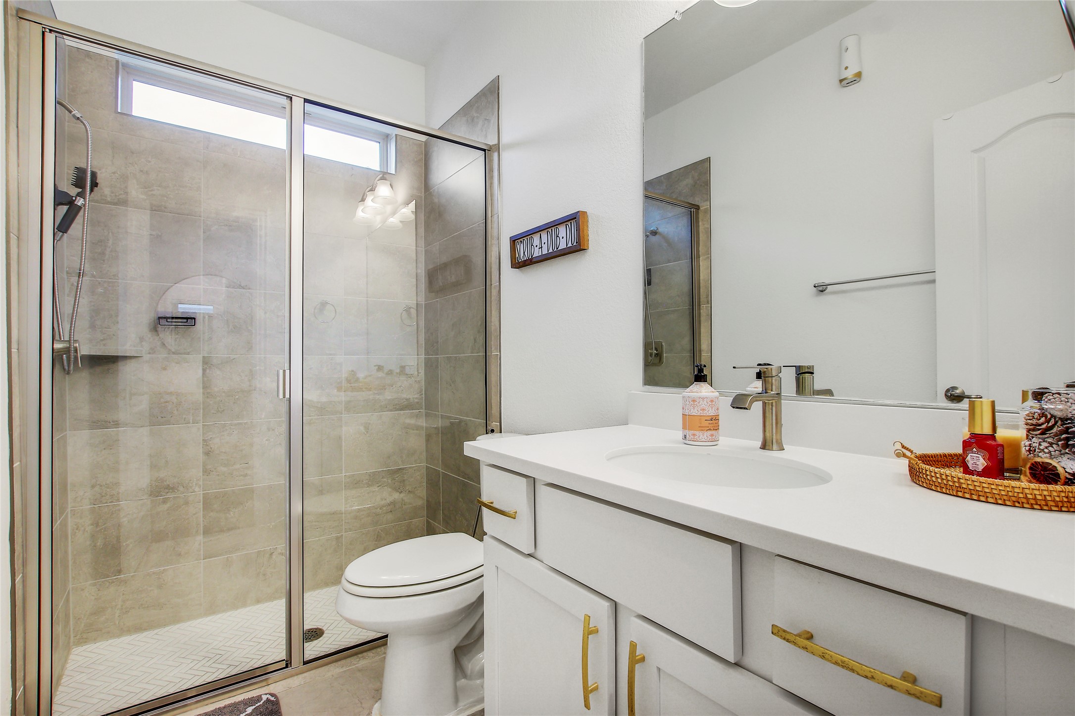 104 Millbend Road Georgetown, TX 78633 - Photo 6 of 40 Modern bath featuring a sleek vanity and a spacious, glass-enclosed shower.